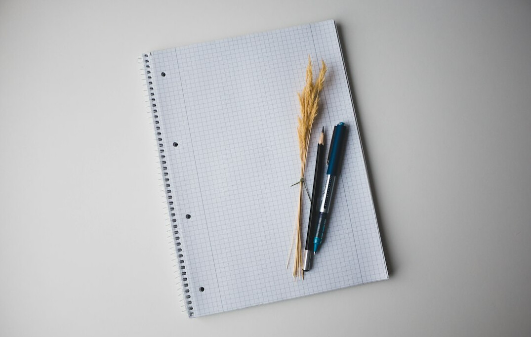 Stack of insurance policy documents and a pen on a wooden desk